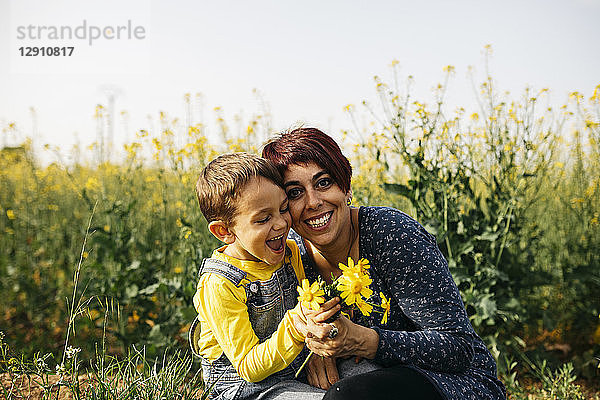 Portrait of happy mother with little son in nature