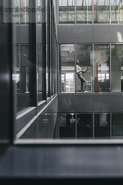Woman standing at office window