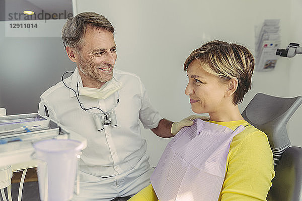 Dentist calming his patient before treatment