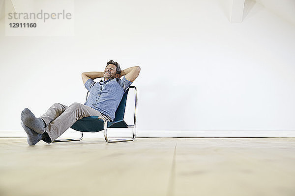 Man sitting in arm chair  daydreaming