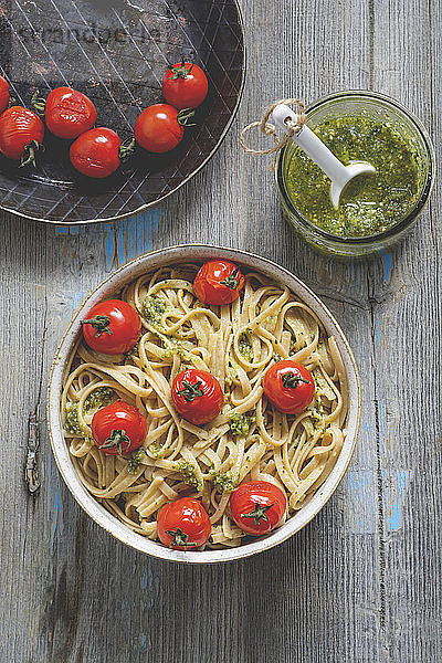 Homemade whole-grain ribbon noodles with pesto and cherry tomatoes