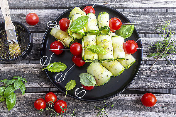 Vegetarian grill skewers  tomato and zucchini slices  rosemary garlic oil