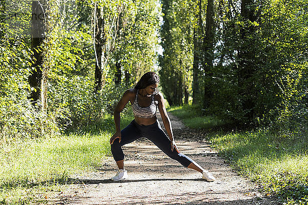 Female athlete warming up for workout in nature