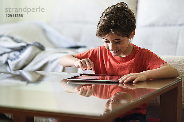Little girl using digital tablet at home