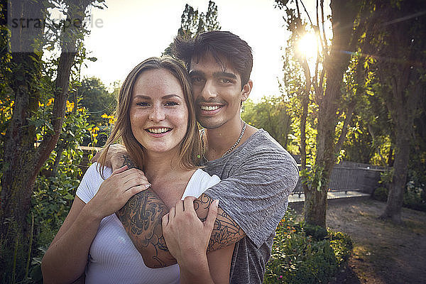 Happy young couple flirting in a park in summer