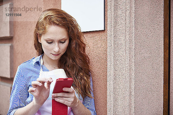 Young woman using a cell phone during a work break