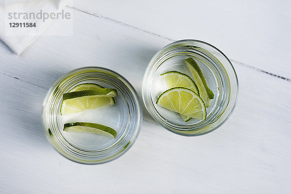 Two glasses of water with sliced limes