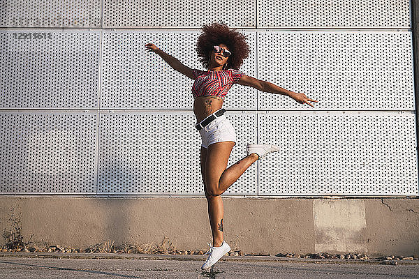 Portrait of fashionable woman jumping in the air