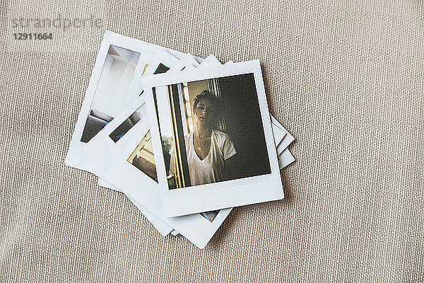 Stack of instant photos of young woman