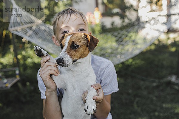 Boy with Jack Russel Terrier in the garden
