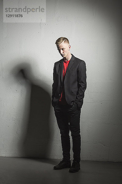 Young man wearing black suit and red t-shirt