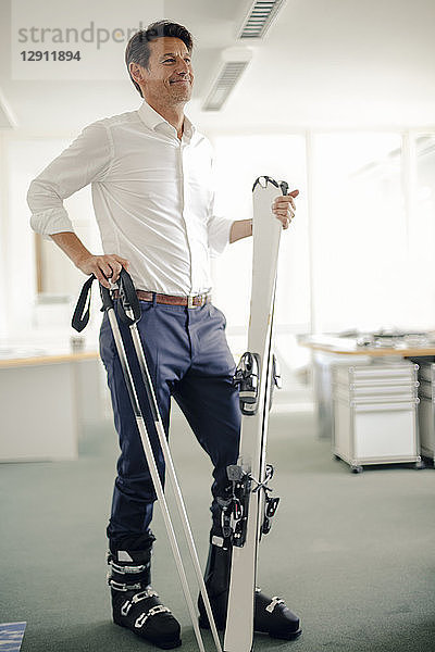 Businessman skiing in office