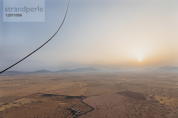 Morocco  view from air balloon at desert and Jbilet mountains by sunrise
