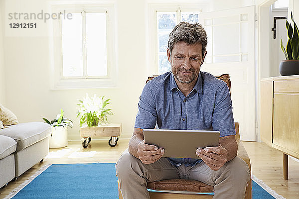 Man using digital tablet at home