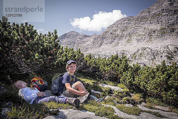 Austria  Salzburg State  Loferer Steinberge  brother and sister resting on a hiking trip in the mountains