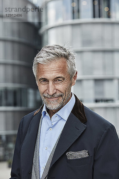 Germany  Duesseldorf  portrait of mature businessman with grey hair and beard outdoors