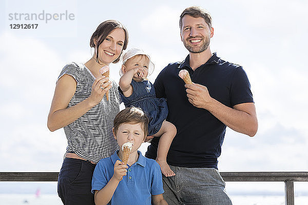 Happy family with two children eating ice cream