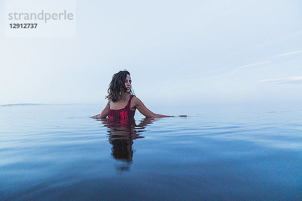 Woman wearing bikini  standing in water of a lake