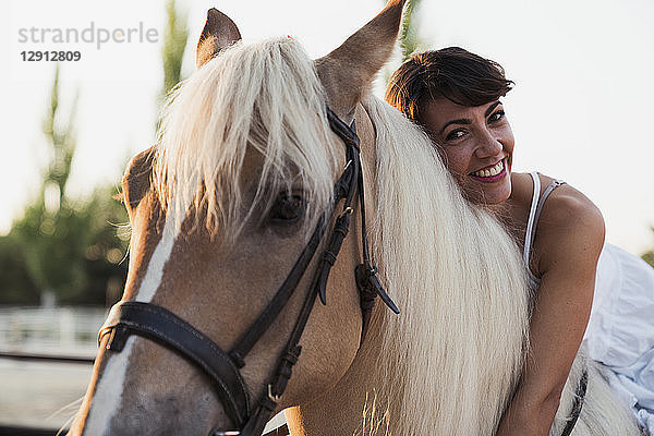 Portrait of smiling woman on riding horse