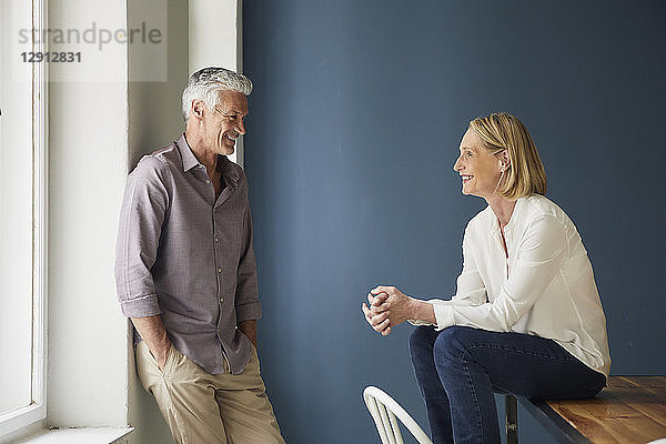 Smiling mature couple relaxing at home