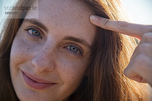 Portrait of smiling young woman with freckles