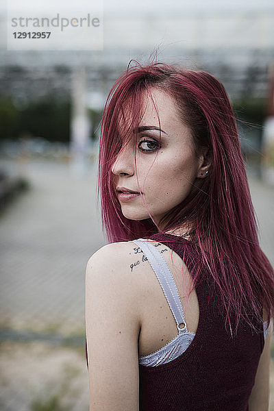 Portrait of young woman with dyed hair outdoors