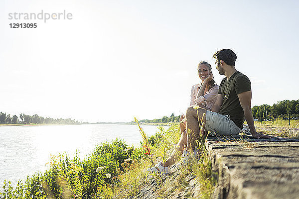 Couple relaxing at the riverside in summer