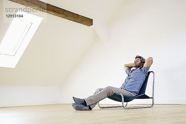 Mature man sitting in arm chair  relaxing at home