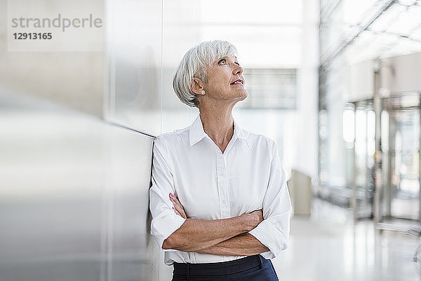 Portrait of senior businesswoman looking up