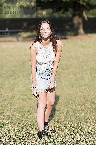 Portrait of smiling young woman standing on a meadow
