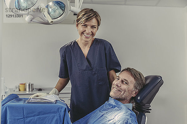 Dental surgeon talking to patient before treatment