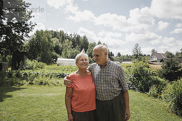 Happy senior couple standing in the garden