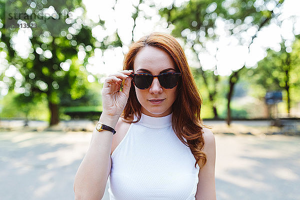 Portrait of redheaded woman wearing sunglasses