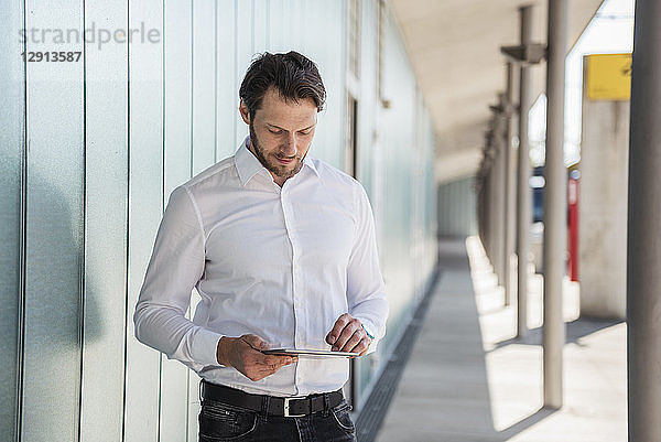 Businessman using tablet outdoors