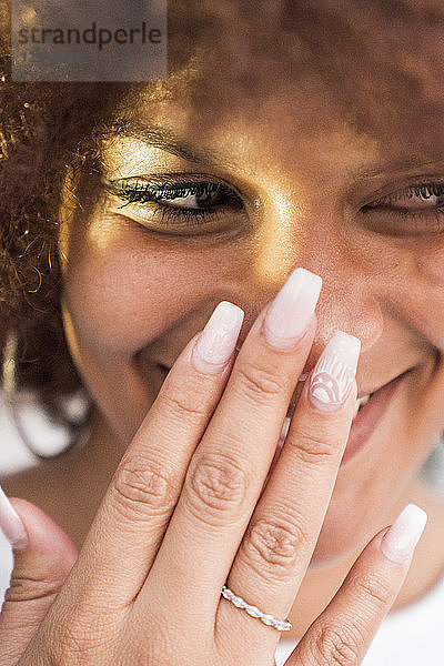 Portrait of laughing young woman with artificial nails