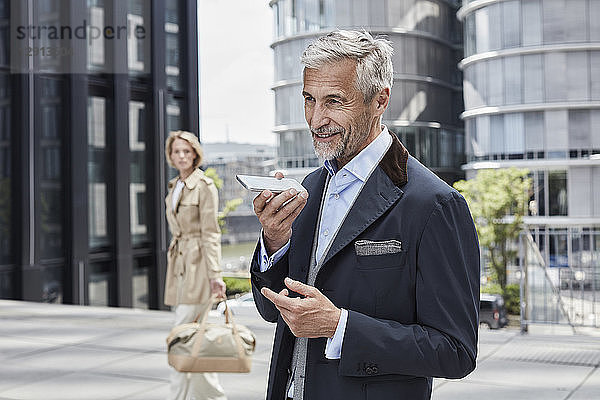 Germany  Duesseldorf  portrait of mature businessman talking on mobile phone