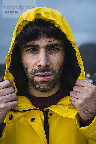 Norway  Lofoten  portrait of young man wearing a rain jacket