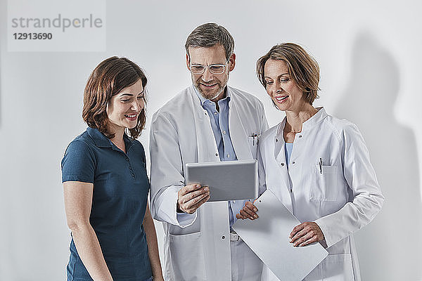 Doctors and medical secretary using tablet