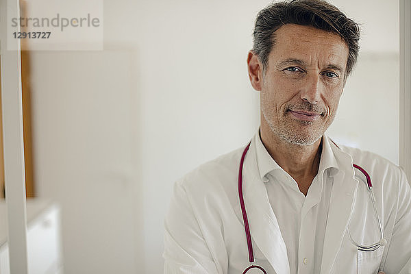 Doctor standing in hospital with stethoscope around neck  portrait