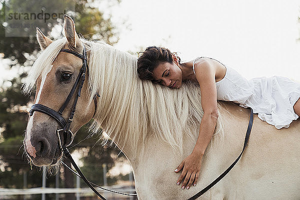 Woman relaxing on horseback