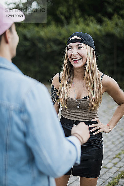 Young woman laughing at man outdoors