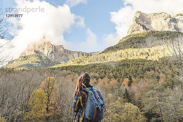 Spain  Ordesa y Monte Perdido National Park  back view of woman with backpack looking at view
