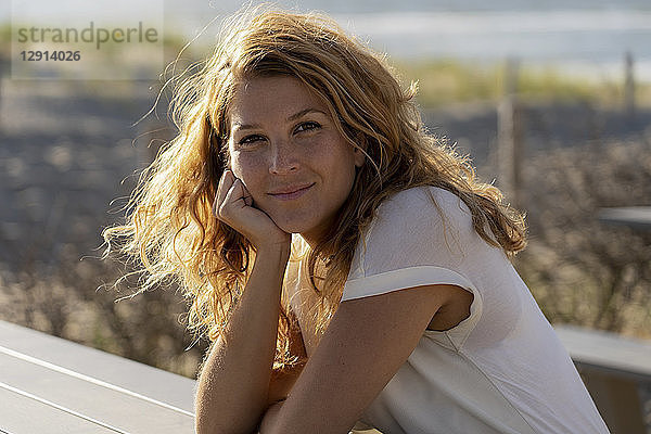 Portrait of a beautiful woman at the beach in summer