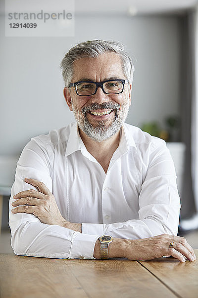 Portrait of smiling mature man at home