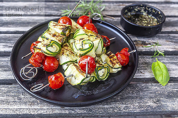 Grilled vegetarian grill skewers  tomato  sheep cheese and zucchini slices  rosemary garlic oil