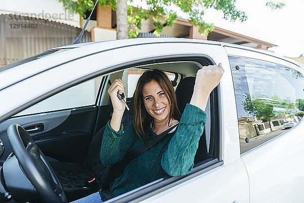 Woman inside of a car making triumph gesture