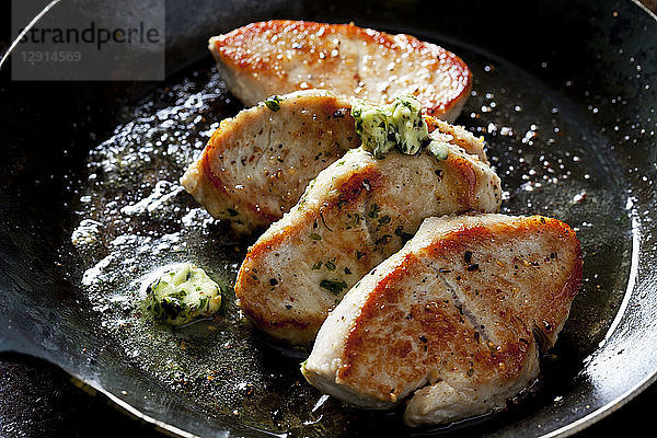 Fillet of turkey with herb butter in pan