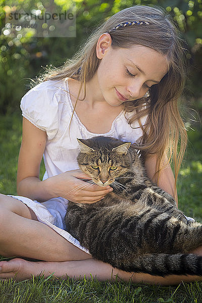 Girl with cat in garden
