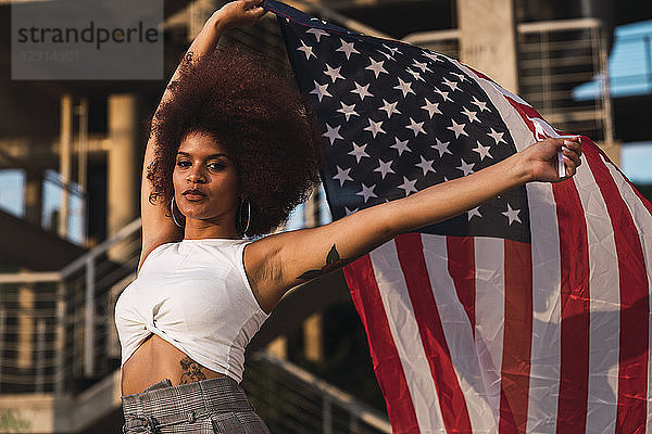 Portrait of young woman with American flag