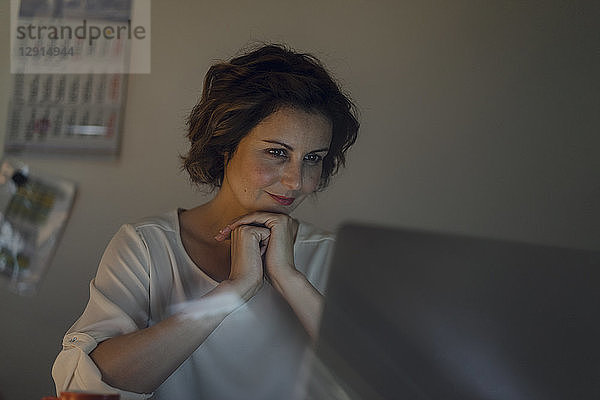 Businesswoman working overtime  using laptop
